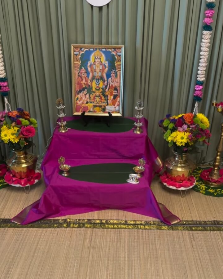 A cora mat backdrop styled for a home pooja