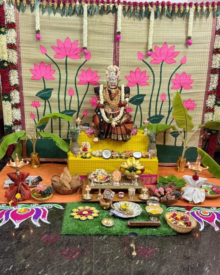 A cora mat backdrop styled for a home pooja